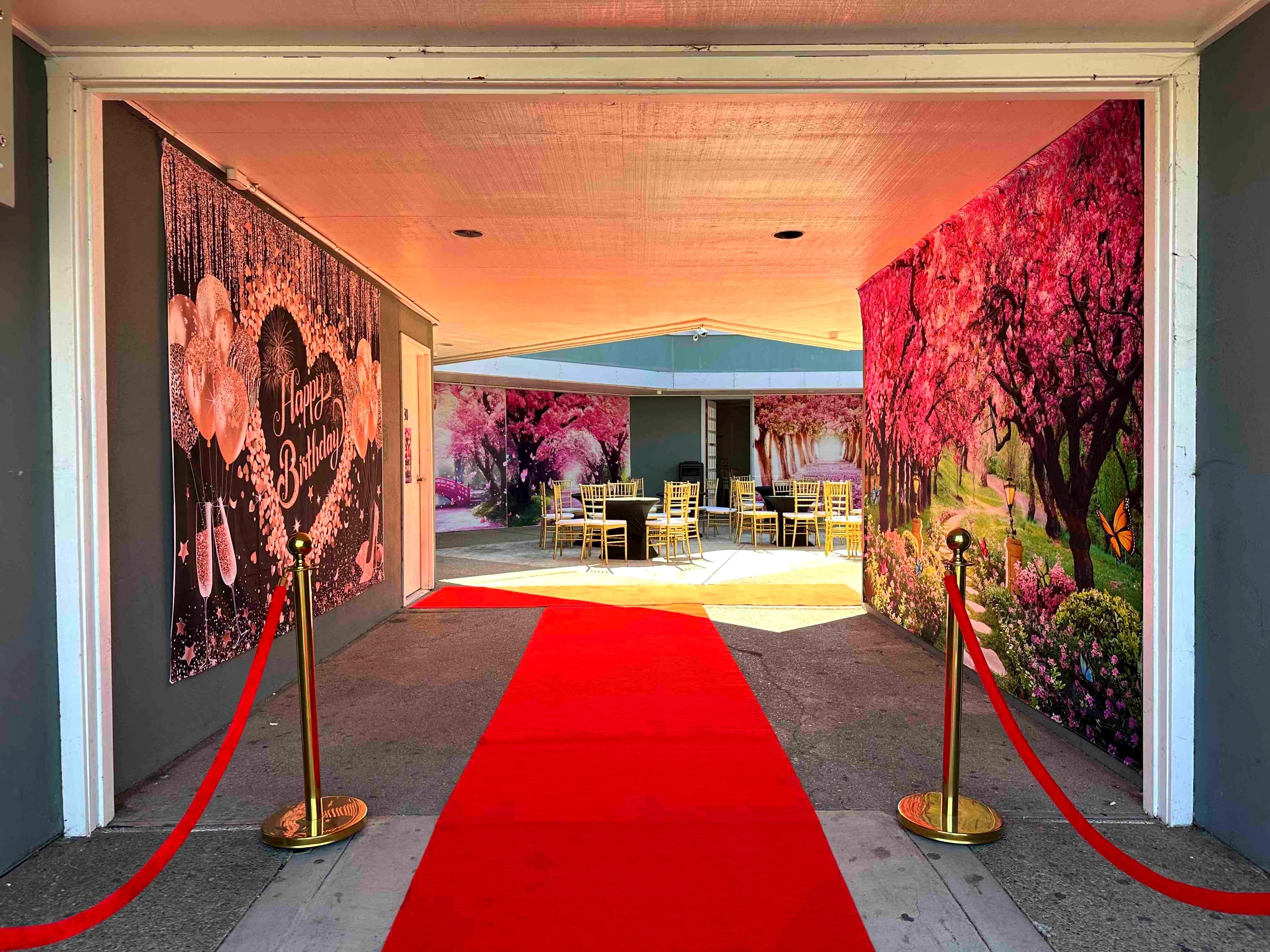 Open-air courtyard set with gold chiavari chairs and floral backdrops